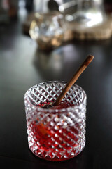 Pink Cocktail glass with ice at a bar counter