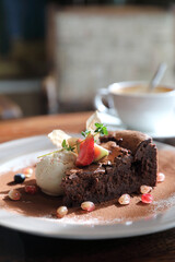 Chocolate cake with ice cream and coffee dessert on wood table