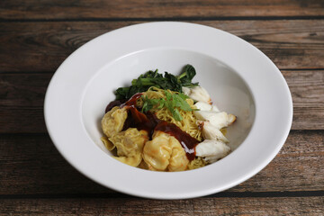 Shrimp dumpling noodles and crab meat on wood background