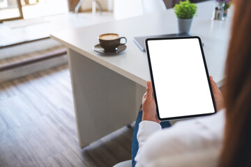 Mockup image of a business woman holding digital tablet with blank white desktop screen