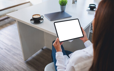 Mockup image of a business woman holding digital tablet with blank white desktop screen