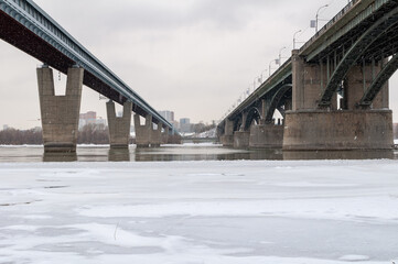 Two bridges in the city across the river. Winter 