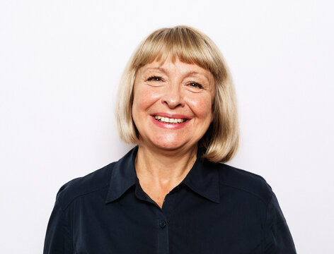 Portrait of senior woman with cute smile over white background