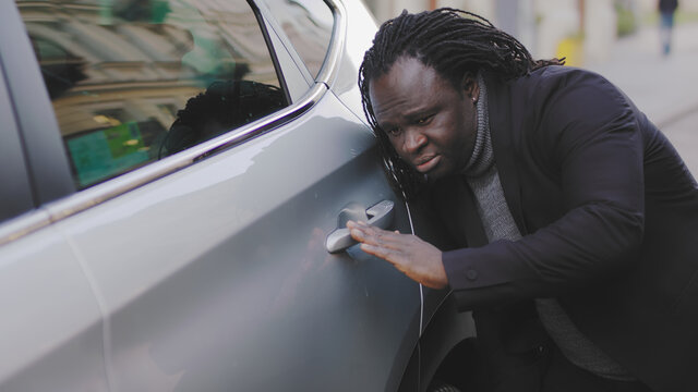 African american black man having big desire to buy new electric car. High quality photo