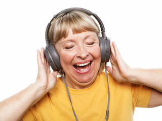 Old people, tehnology and emotion concept: Cheerful elderly woman listening to music
