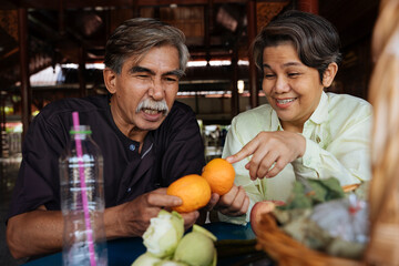 Fototapeta premium Cheerful asian senior elderly prepare alms to make a merit in temple.