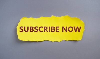 SUBSCRIBE NOW text written on yellow torn paper.Conceptual hand writing showing Subscribe Now....