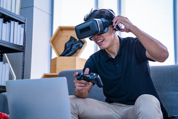 asian man playing games online with vr goggles