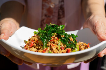 Thai Basil Chicken in white bowl.