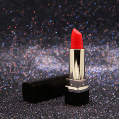 red lipstick on black shiny background