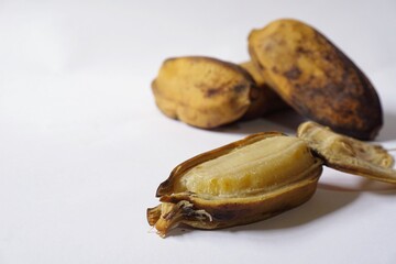 Grainy look of Pisang Rebus or Boiled Banana in white background. Pisang Kepok. Selective focus 