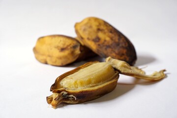 Grainy look of Pisang Rebus or Boiled Banana in white background. Pisang Kepok. Selective focus 
