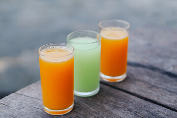 Closeup orange and guava juice on wood background, drink for healthy concept, selective focus