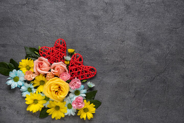 Fototapeta na wymiar Valentine's day or Wedding romantic concept with flowers and red hearts on grey background. Top view, copy space.