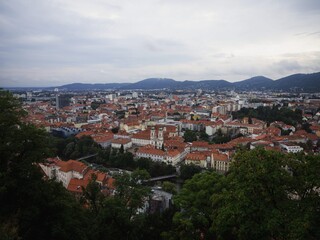 Cityscapa panorama of Graz historic city centre from Schlossberg castle hill in Styria Austria alps mountains Europe