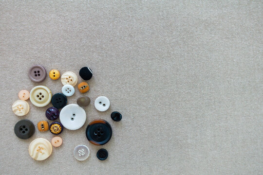 ฺButtons, in various form, style, color and size, for handcraft and dressmaking, on a copy space background.