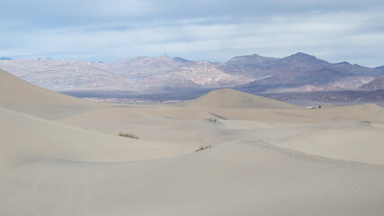 Fototapeta na wymiar Sand Dunes in the Desert with Mountains in the Background at Death Valley National Park