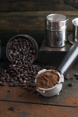 coffee bean cup and porta filter with coffee powder inside and Vietnam Drip Coffee on wooden table