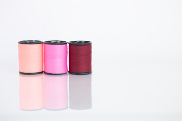 Red and pink set thread isolate on white background, craft and sewing tool