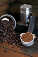coffee bean cup and porta filter with coffee powder inside and Vietnam Drip Coffee on wooden table