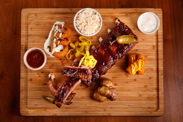 Baked pork knuckle with fried dark bread on a wooden chopping Board