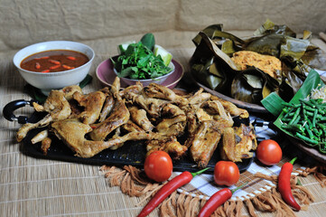 This is Ayam Bakar or Ayam Panggang. Ayam Bakar is one of the favorite dishes in Indonesia. Half-cooked chicken with spices then grilled over charcoal