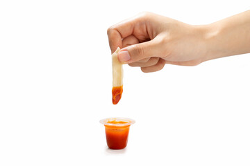 hand holding  french fries dip to ketchup or tomato sauce isolated on a white background