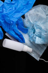  Coronavirus, covid 19 prevention concept . Nasal spray , medical gloves and mask on black