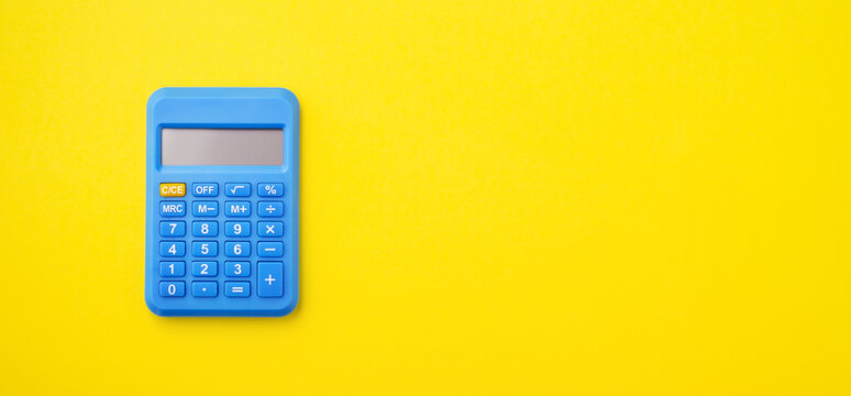 Blue calculator on yellow background
