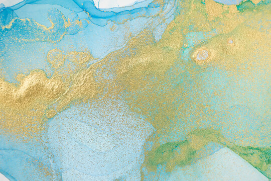 Gradient blue and green ink background. Gold print texture.