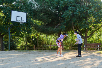 young couple playing basketball with virtual reality glasses