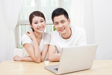 A young Couple Using Laptop at Home 