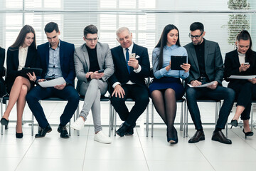 group of business people use their gadgets before starting a business meeting