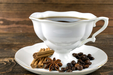 cup of coffee and anise on a wooden background