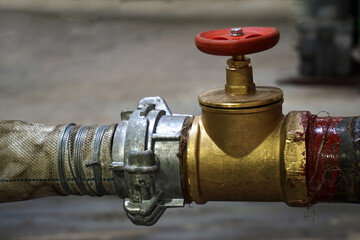 Fireplug with connected hose. Close-up.