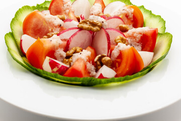 Low carb vegetable salad with walnuts and homemade vinaigrette sauce