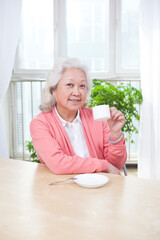 An old Senior woman holding a tea cup 