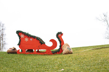 Big red sledge stands on a lawn
