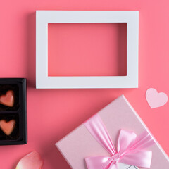 Valentine's Day design concept background with pink petals and gift box.