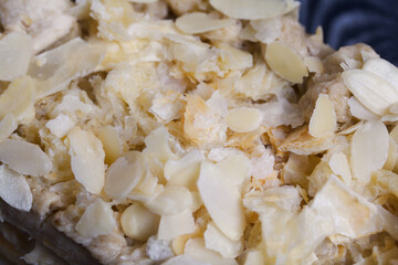 Puff pastry cake. With banana cream and almond petals.