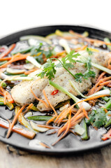 chinese style steamed fish fillet with vegetables on hot plate