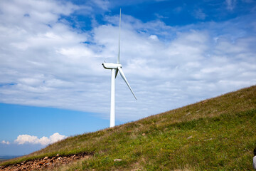 Fototapeta na wymiar Wind turbines under blue skies