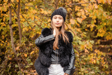Portrait of beautiful woman in autumn park