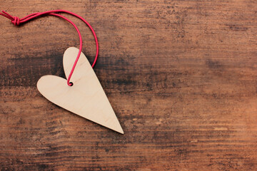 Blank wooden heart for painting or decoupage on wooden table background. Top view, copy space. Valentines day concept
