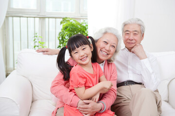 Happy grandparents and grandchildren are playing in the living room 