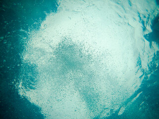 Underwater shot of air bubbles in clear water in a pool
