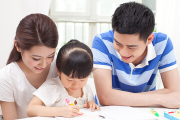 A happy family of three drawing together