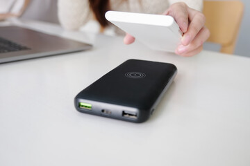 Female Charging Smartphone Using portable Wireless fast Charging  at work