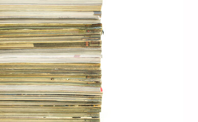 A stack of old magazines with shabby pages on white background with copy space for text.