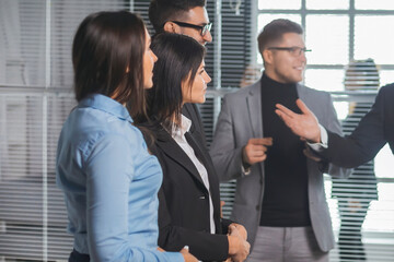 project Manager and working group standing in the conference room.
